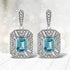 .925 Sterling Silver 7x5MM Emerald Shape Blue Topaz and Diamond Accent Art Deco Halo Style Drop and Dangle Earrings (I-J Color, I1-I2 Clarity) by Bids.com