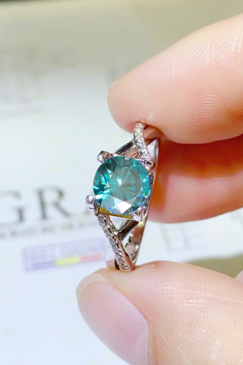 1 Carat Aqua Blue Brilliant Round Cut Sparkala™ Crisscross Platinum Over Pure Sterling Silver Ring - DestGlow