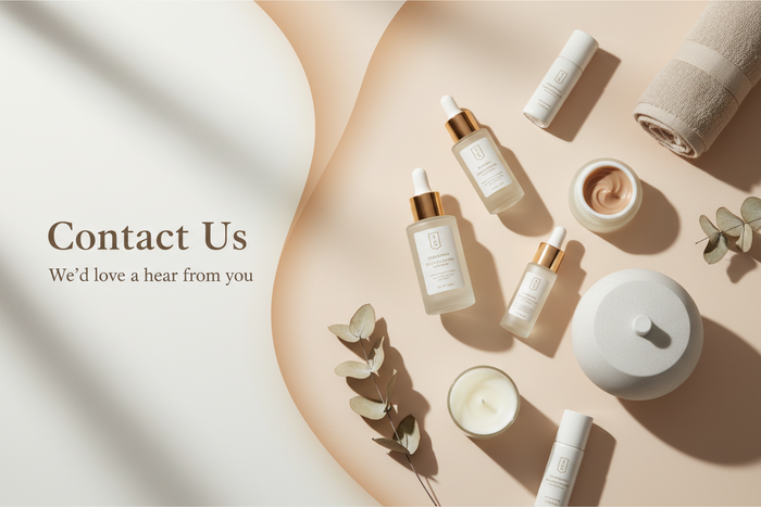 Cosmetic products on a beige surface with text inviting contact.