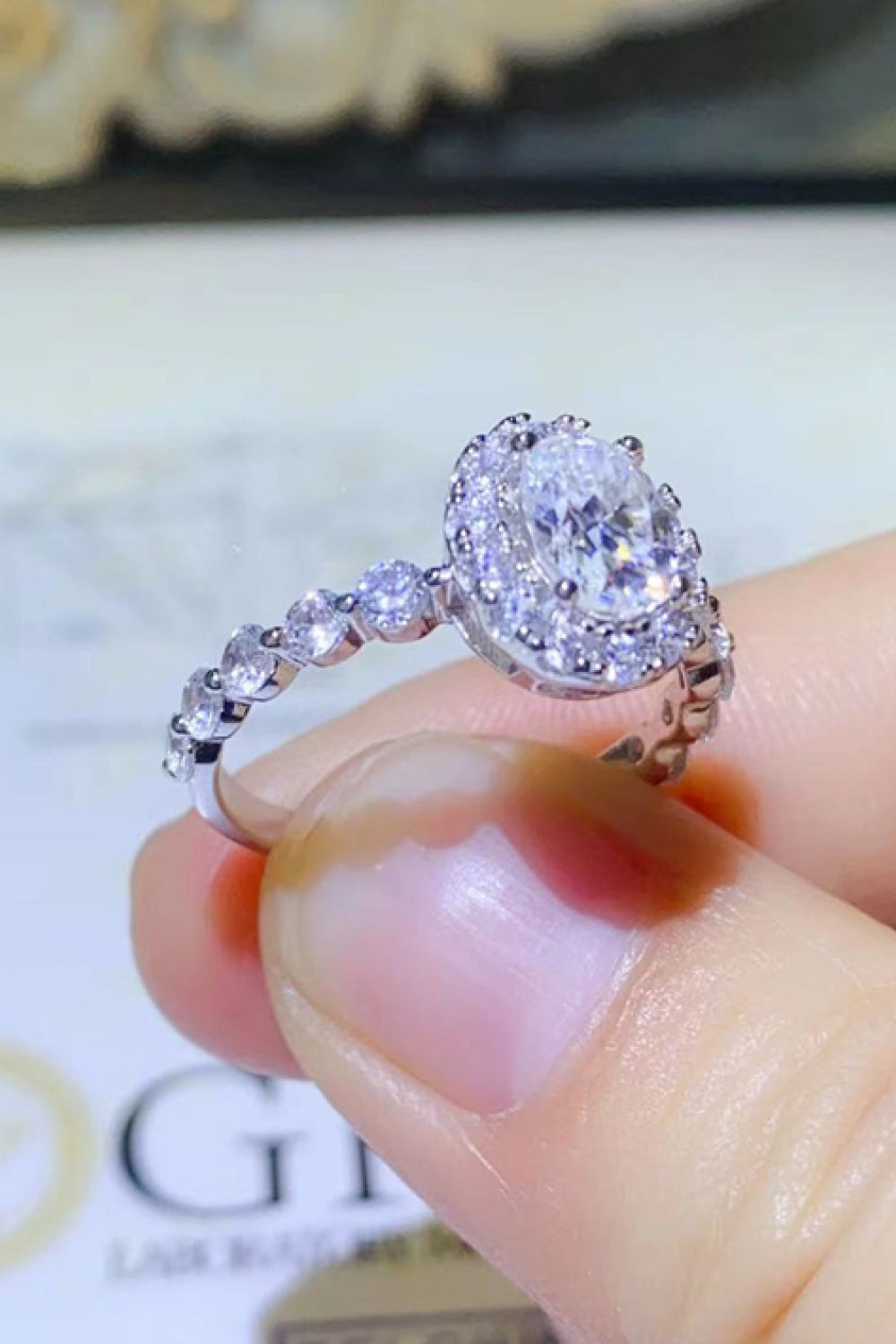 Adored 1 Carat Oval-Cut Sparkala™ Platinum Over Pure Sterling Silver Halo Ring by Sparkala
